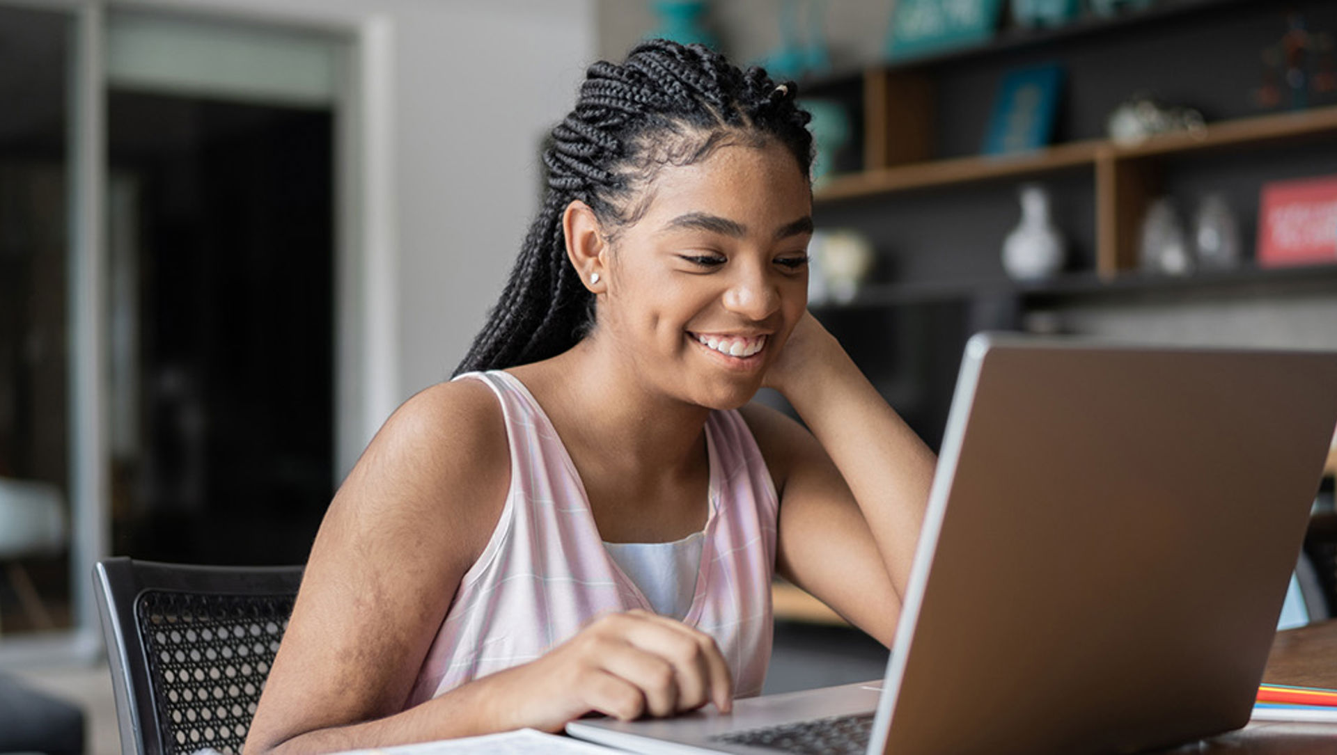 Teenage girl at desk on computer