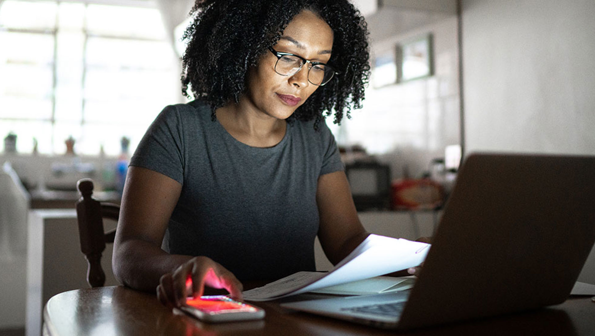 Woman checking her bill in front of a laptop