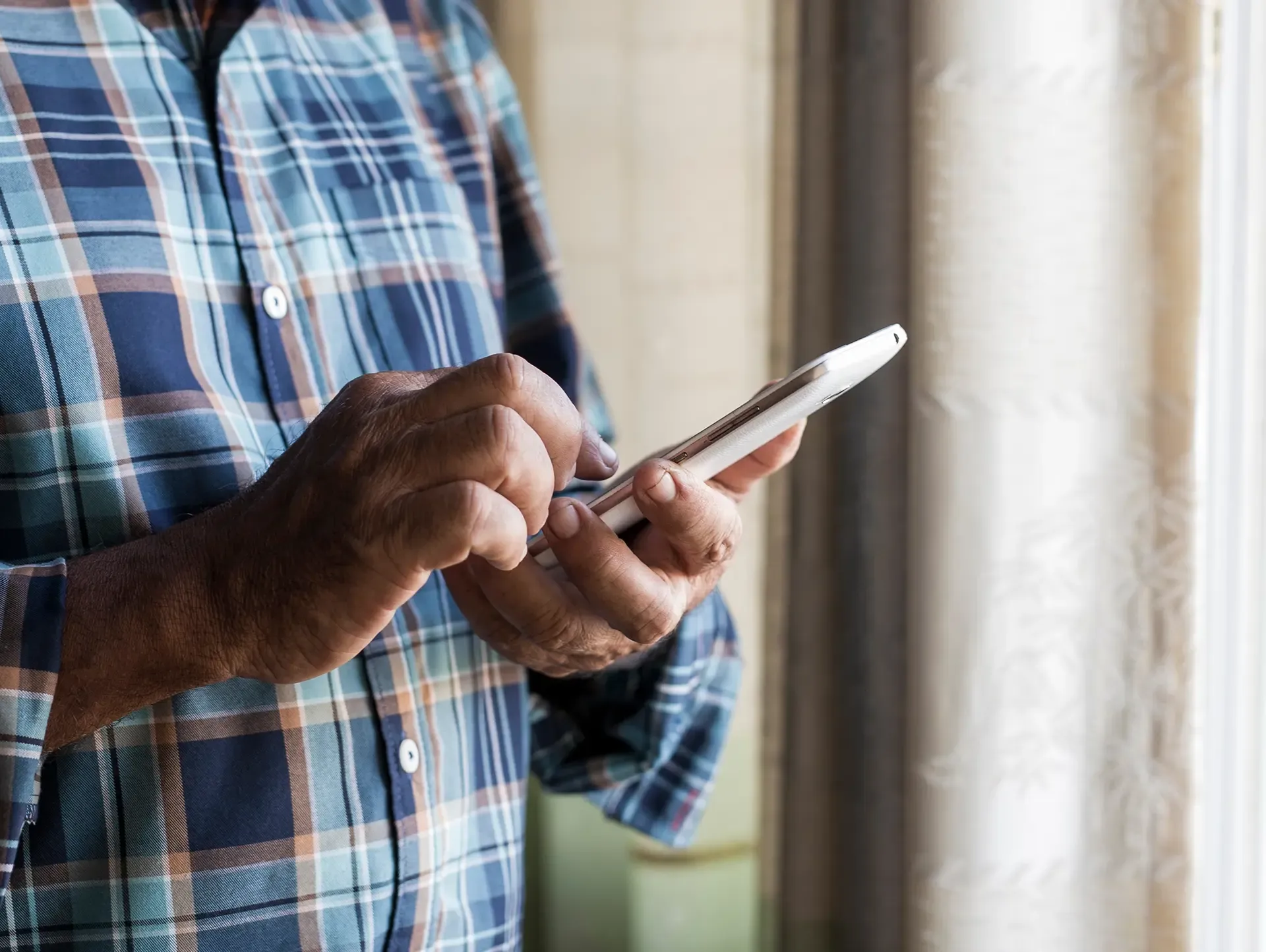 Man looking at his older model phone