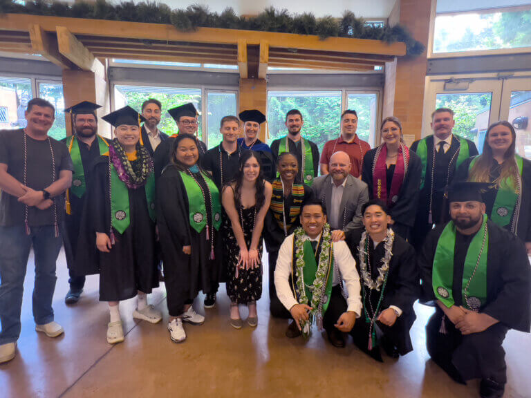 A group shot of veterans' in college graduation regalia