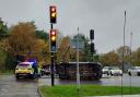 Dramatic image of an overturned car at a red light