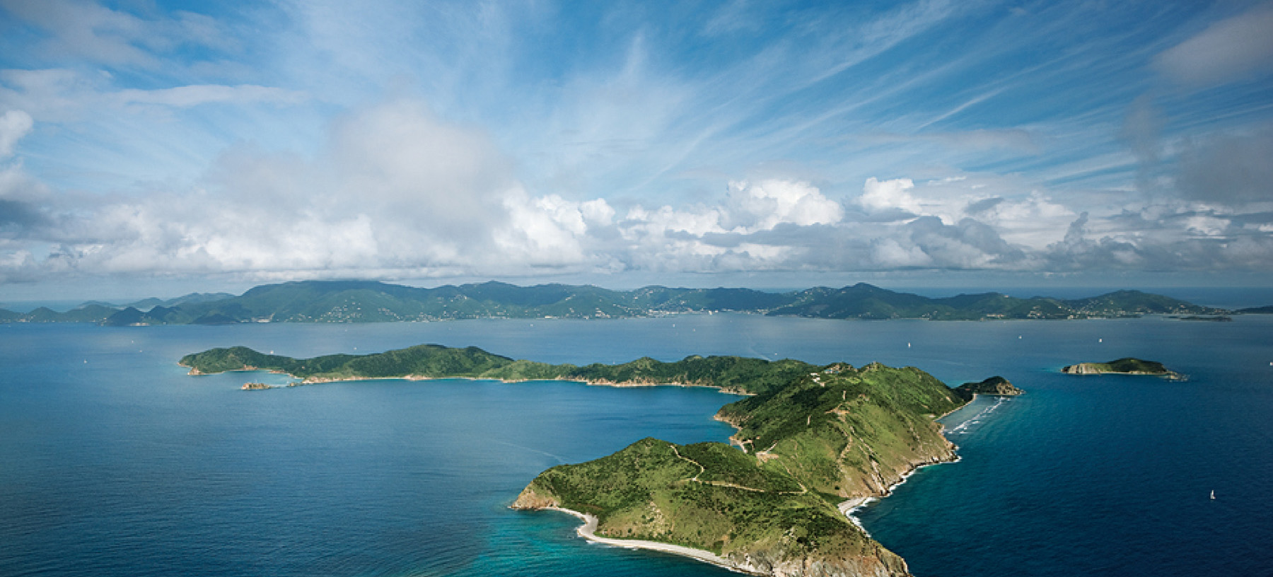 Aerial image of Peter Island Resort surrounded by water.