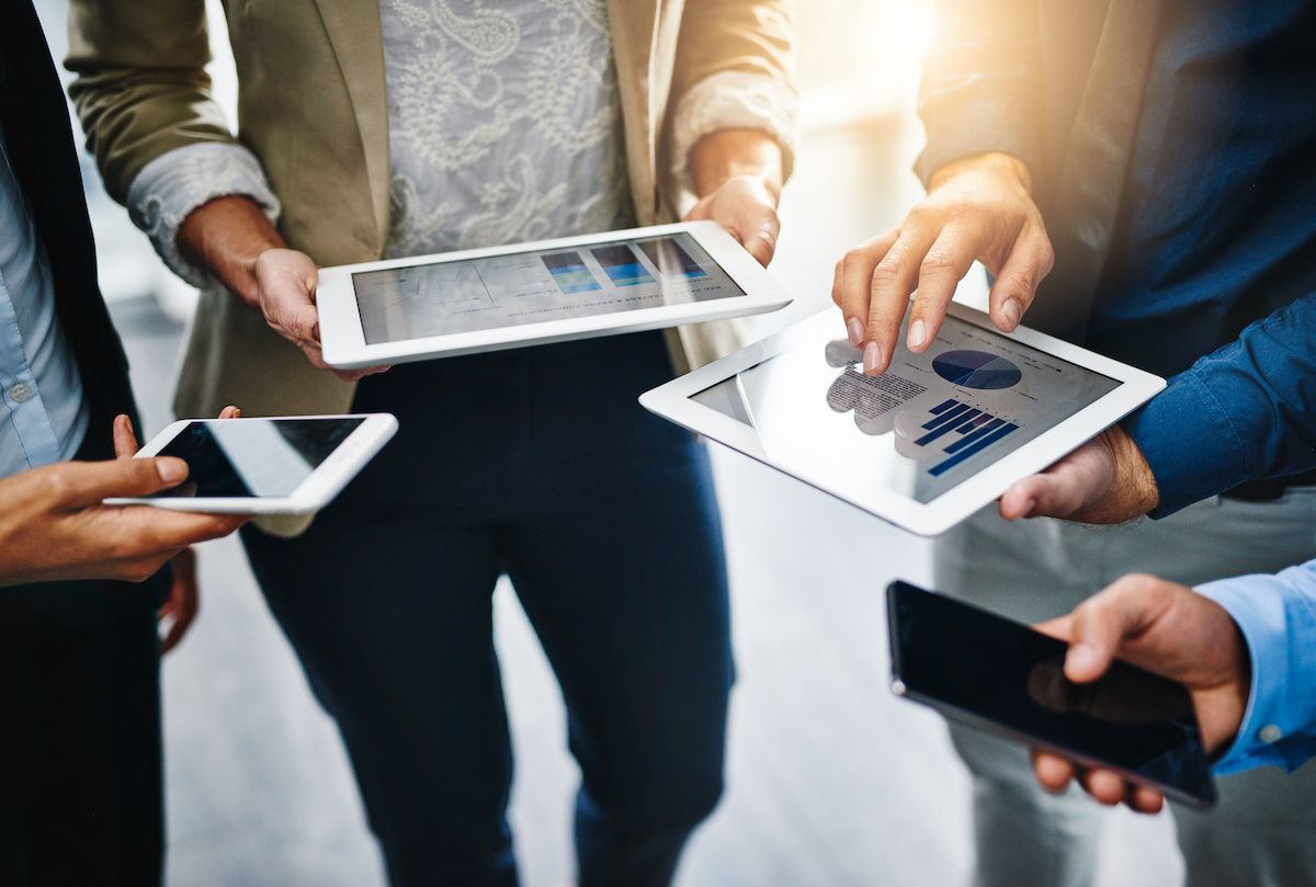 Business group, hands and technology with tablet and phone in a office with online data. Contact, collaboration and web management team on tech with sales charts and social network for planning | ©By Donson/peopleimages.com | Adobe Stock