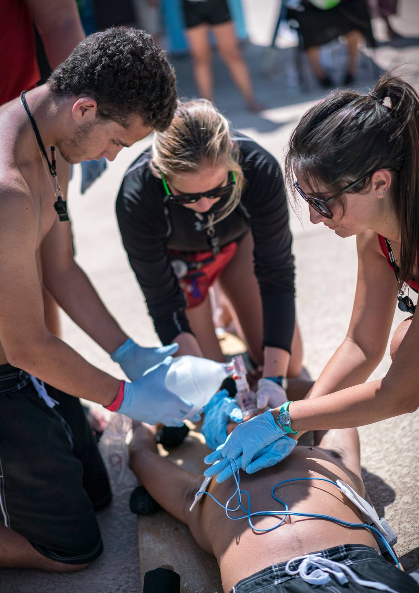 Three lifeguards performing a water safety drill