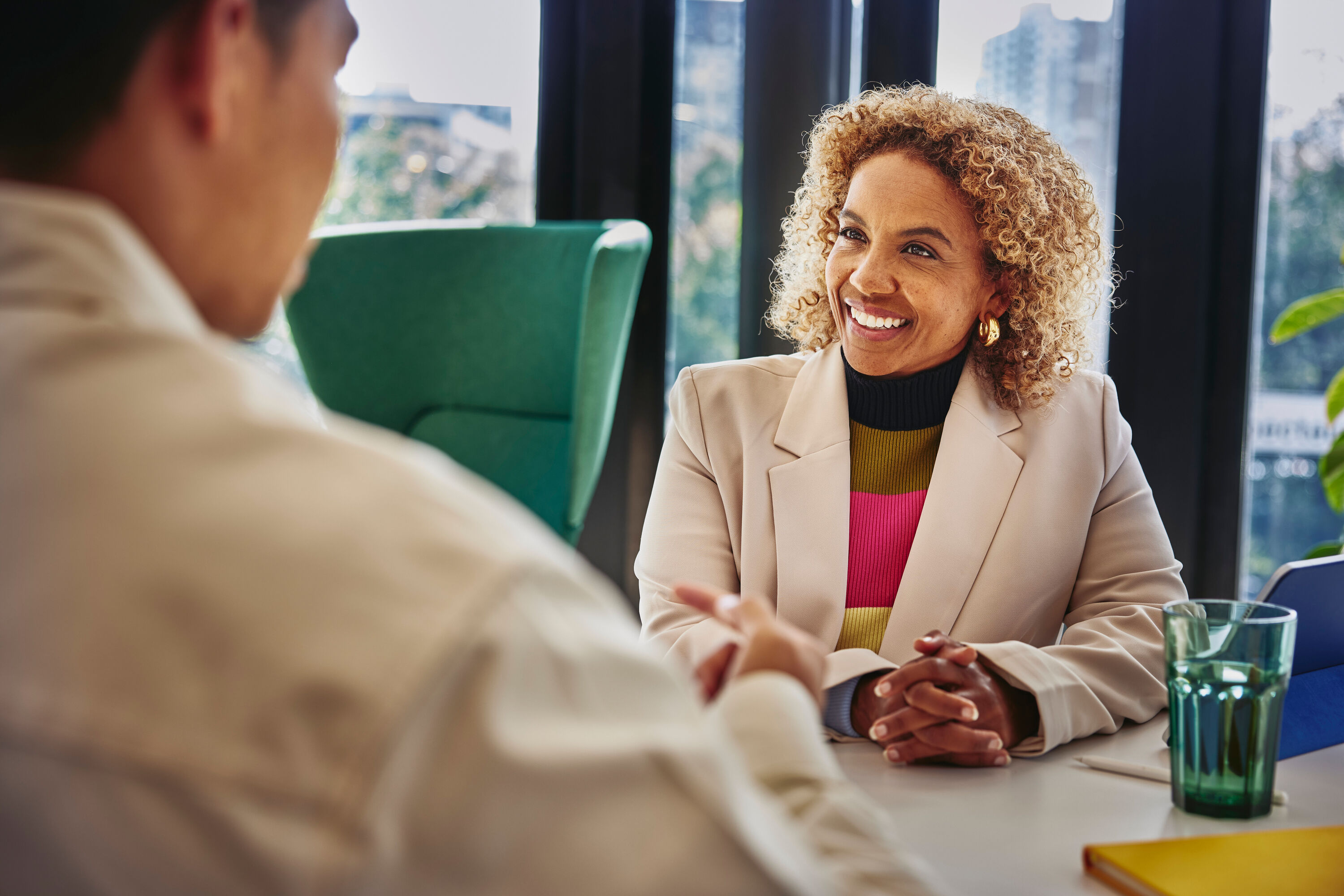 an image of a man talking with a woman while seated in front of her