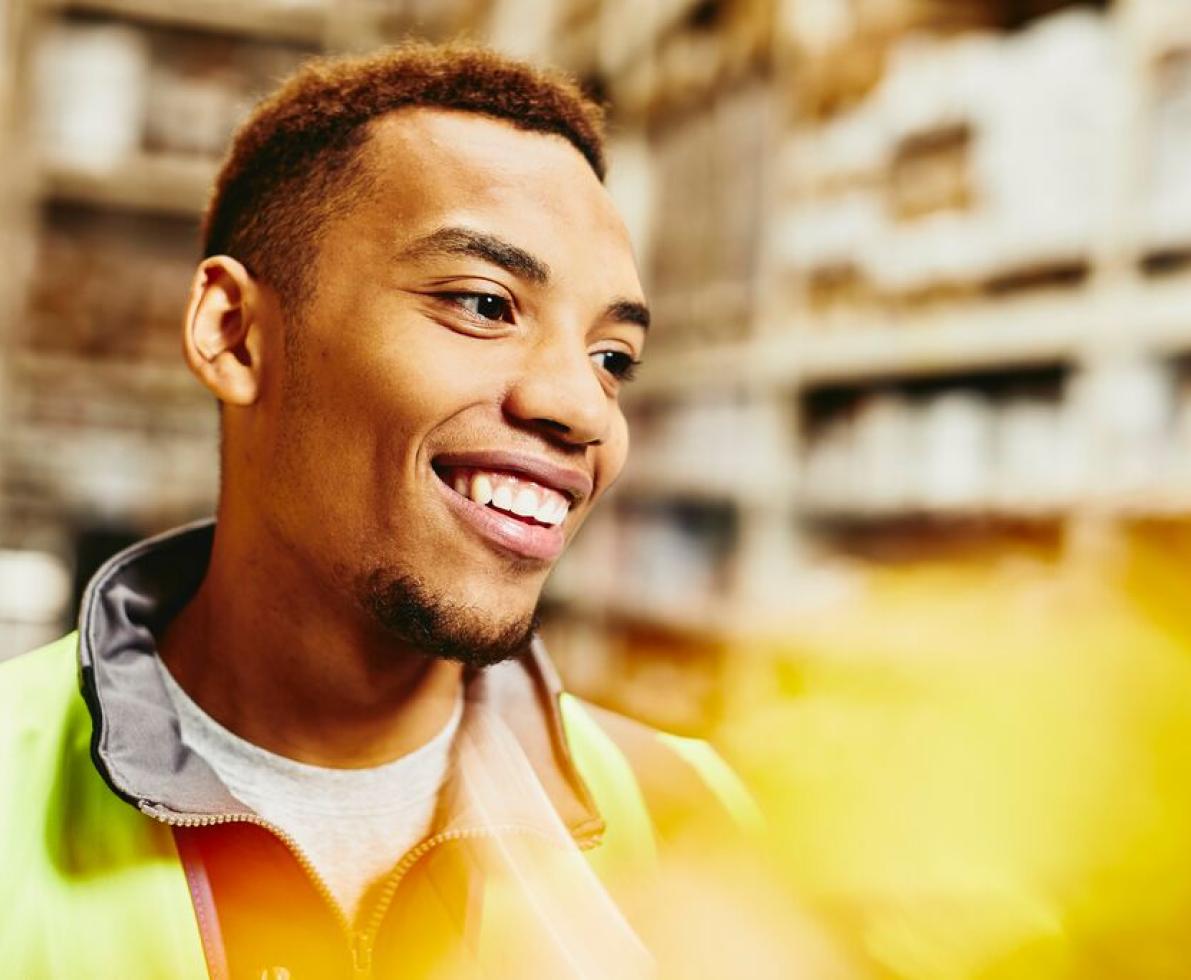 A photo of a man working as a forklift driver