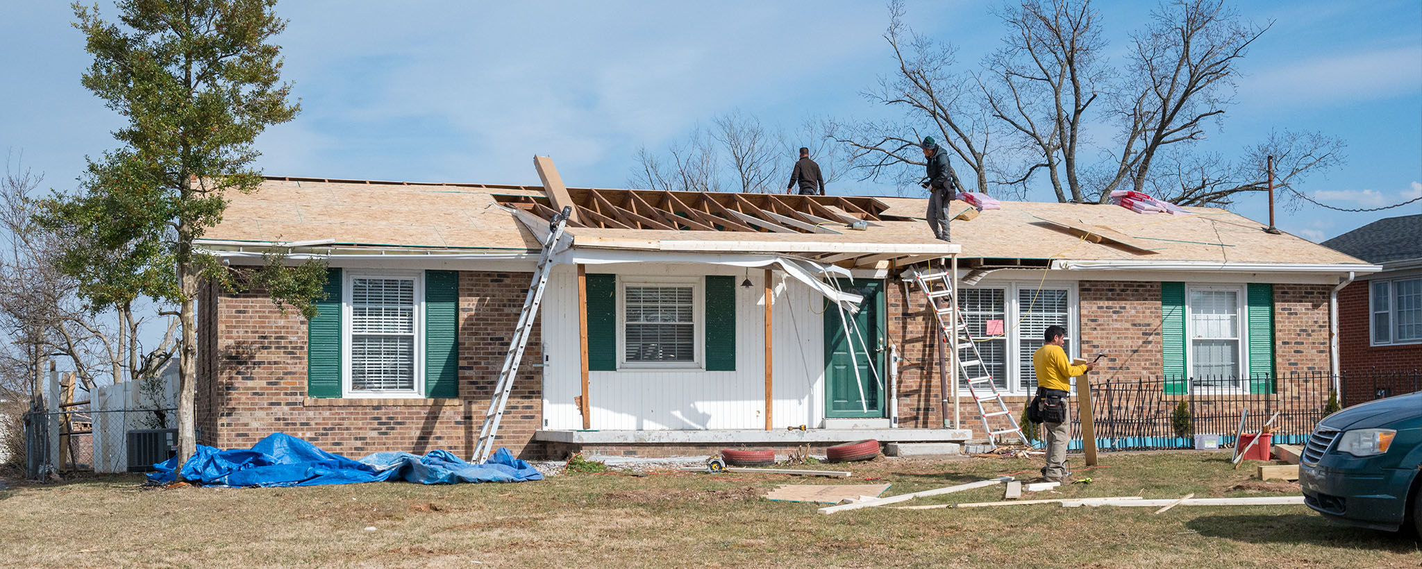 Working repairing a house roof