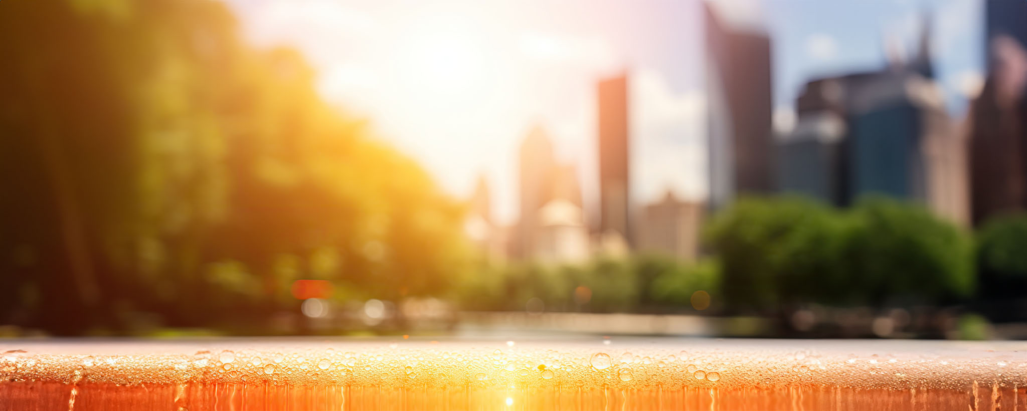 the skyline of a city on a hot summer day as the sun beats down. 