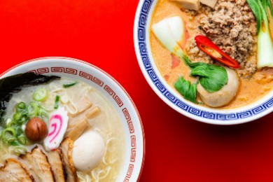 Two bowls of Heddon Yokocho ramen on a red table