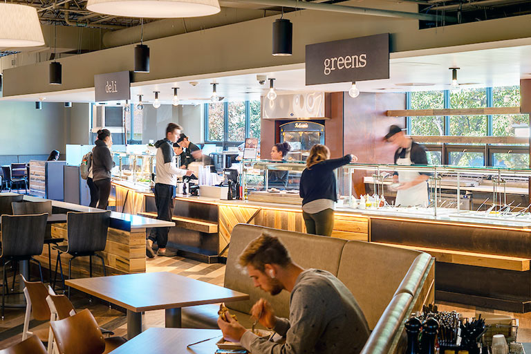 busy students are served food from the different eateries in The Table dining area in the Student Center