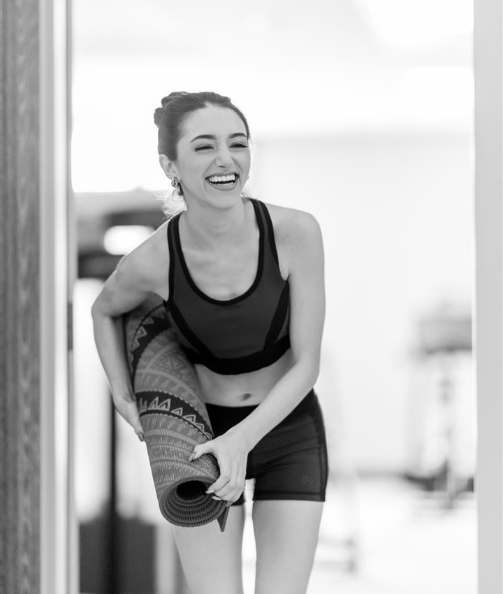 A girl holding a yoga mat