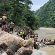 There were 65 people on board the two buses that were swept into a swollen river in Nepal, but rescuers have so far only recovered 14 bodies (Ramesh Paudel/AP)