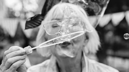 Senior woman blowing bubbles