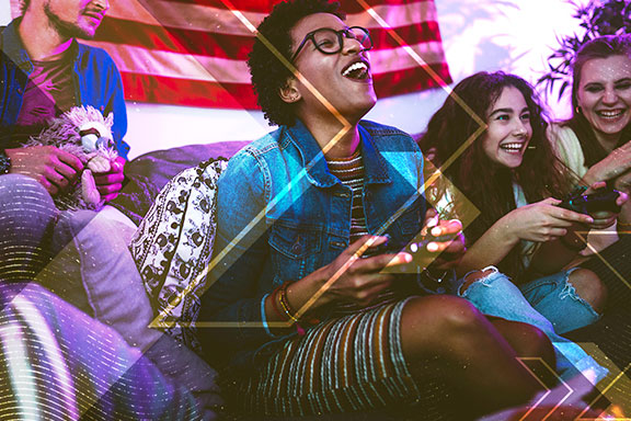 Group of young people laughing and holding game controllers