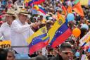 Venezuelan opposition presidential candidate Edmundo Gonzalez, accompanied by wife Mercedes, flashes a thumbs up at supporters as he arrives to his campaign rally in Barinas, Venezuela (Ariana Cubillas/AP)