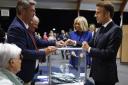 French President Emmanuel Macron, right, votes for the second round of the legislative elections in Le Touquet-Paris-Plage (Mohammed Badra/AP)