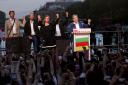 Far-left La France Insoumise – LFI – (France Unbowed) founder Jean-Luc Melenchon, right, clenches his fist with other party members after the second round of the legislative elections on Sunday (Thomas Padilla/AP)