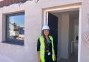 Somerset Council project officer Alex Williams outside one of the new council houses on Rainbow Way in Minehead.