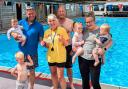 (L-R) Riley & Kit Kennett, Martin Greenway presenting the cheque to Liz Hurry (Chair of WiveyPool) Chris Briggs, and Darcie, Oscar & Charmaine Veryard