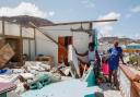 Shermaine Baptiste, left, and a friend look into her destroyed bedroom after it was hit by Hurricane Beryl in Clifton, Union Island, St Vincent and the Grenadines, Thursday, July 4, 2024. Lucanus Ollivierre/AP)