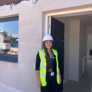 Somerset Council project officer Alex Williams outside one of the new council houses on Rainbow Way in Minehead.