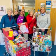 Rossetti House residents collecting food donations for this year's Harvest Festival.