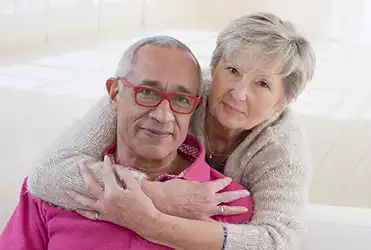 senior woman hugging husband