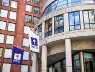 Front facade of Stern building with NYU flag