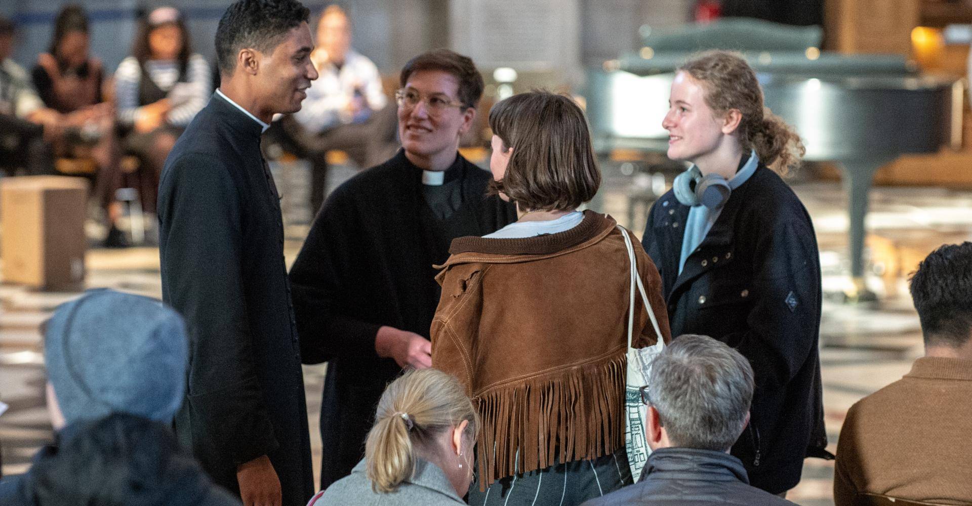 clergy priest talking to worshippers