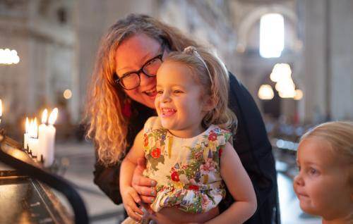 family children mother candles prayer smiling