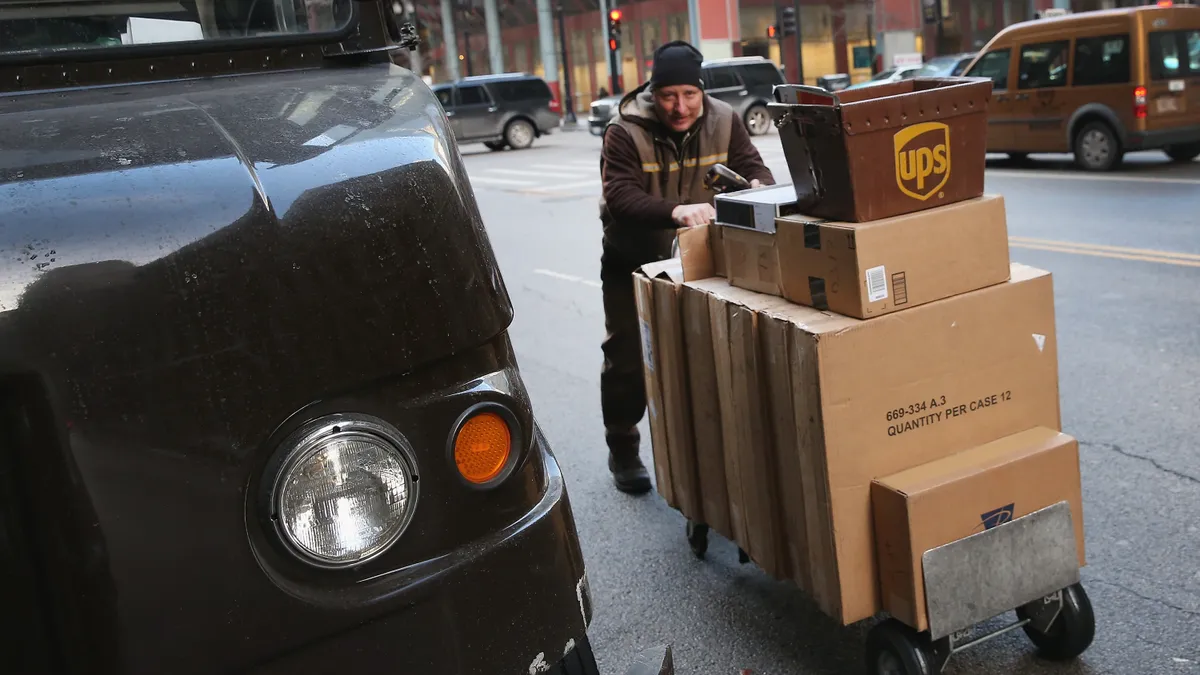 A UPS worker delivers packages on December 26, 2013 in Chicago, Illinois.