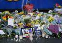 Lit candles among the flowers and messages left in tribute to Nottingham Panthers' ice hockey