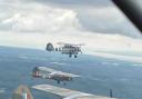 Martin Baldock flying Auster with the half D-Day stripes