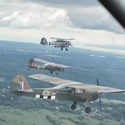 Martin Baldock flying Auster with the half D-Day stripes