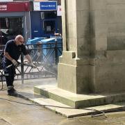 The town centre cenotaph being cleaned on the day of the 80th anniversary of D-day