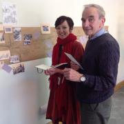 Artist Laurence Dube Rushby getting a hand with the postcard hoardings project from Swindon historian Bob Townsend