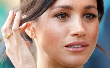 The Duchess of Sussex pictured wearing a gold signet ring in 2018