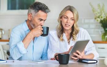 Couple doing paperwork and paying bills at home