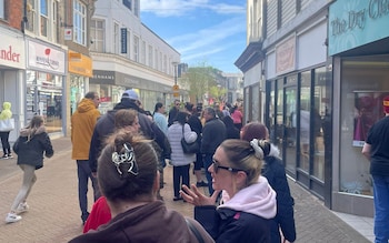 People queue outside Smile Dental Care to register for NHS care