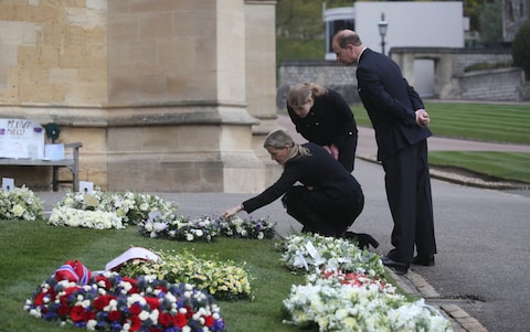 Earl and Countess of Wessex view flowers outside St George's Chapel