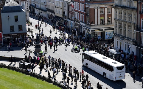 Police hold back the crowds as a coach arrives outside St George's Chapel, Windsor Castle