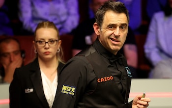 Ronnie O'Sullivan makes an expressive face during his World Championship quarter-final against Stuart Bingham with referee Desislava Bozhilova in the background