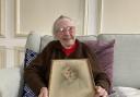 Joan Hewetson with a drawing of herself as a child