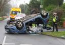 Road partially closed as car overturns