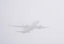 A plane takes off in misty conditions from  Gatwick airport