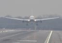 A plane lands in misty conditions at Gatwick Airport