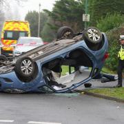 Road partially closed as car overturns