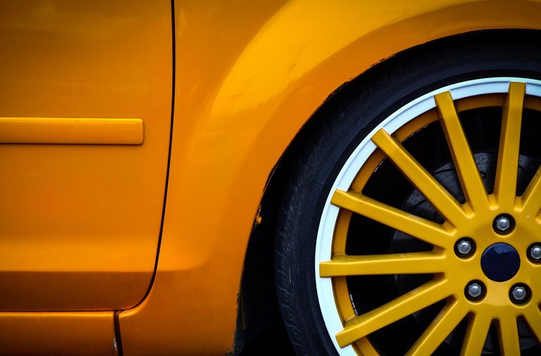 Rear of an orange car with a powder coated orange wheel