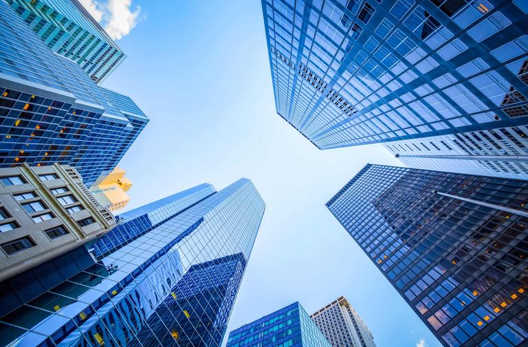 Skyscrapers with powder coated facades viewed from the ground up 