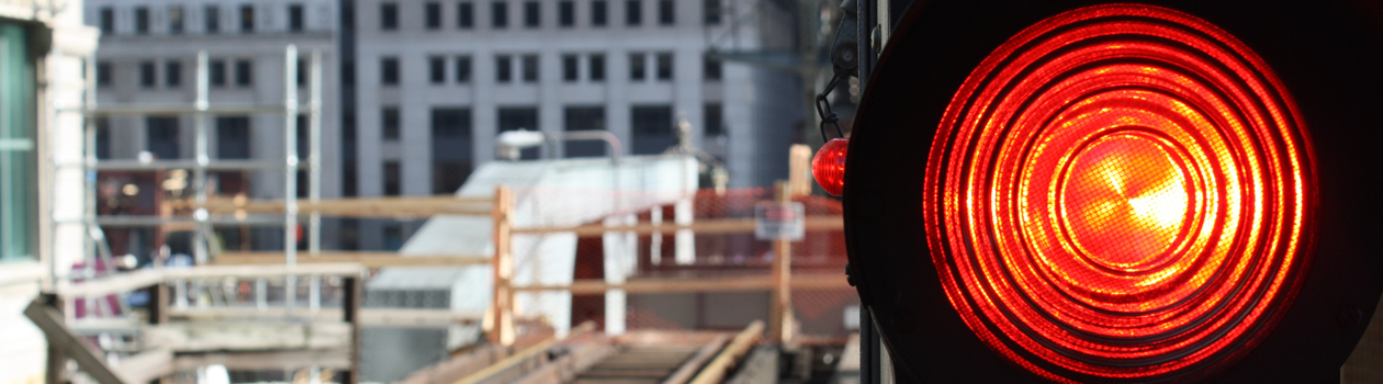 A red signal commands trains to stop before a construction area